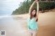 A woman in a bikini standing on a beach.