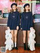 A couple of girls standing next to each other in front of a counter.