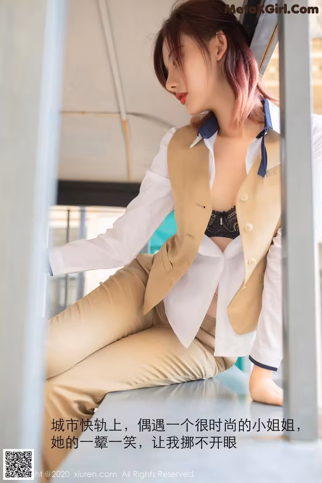 A woman in a white shirt and tan pants sitting on a bench.