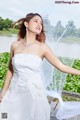 A woman in a wedding dress posing for a picture.