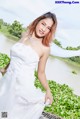 A woman in a wedding dress posing for a picture.