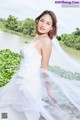 A woman in a wedding dress posing for a picture.