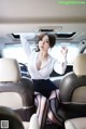 A woman sitting in the back seat of a car.